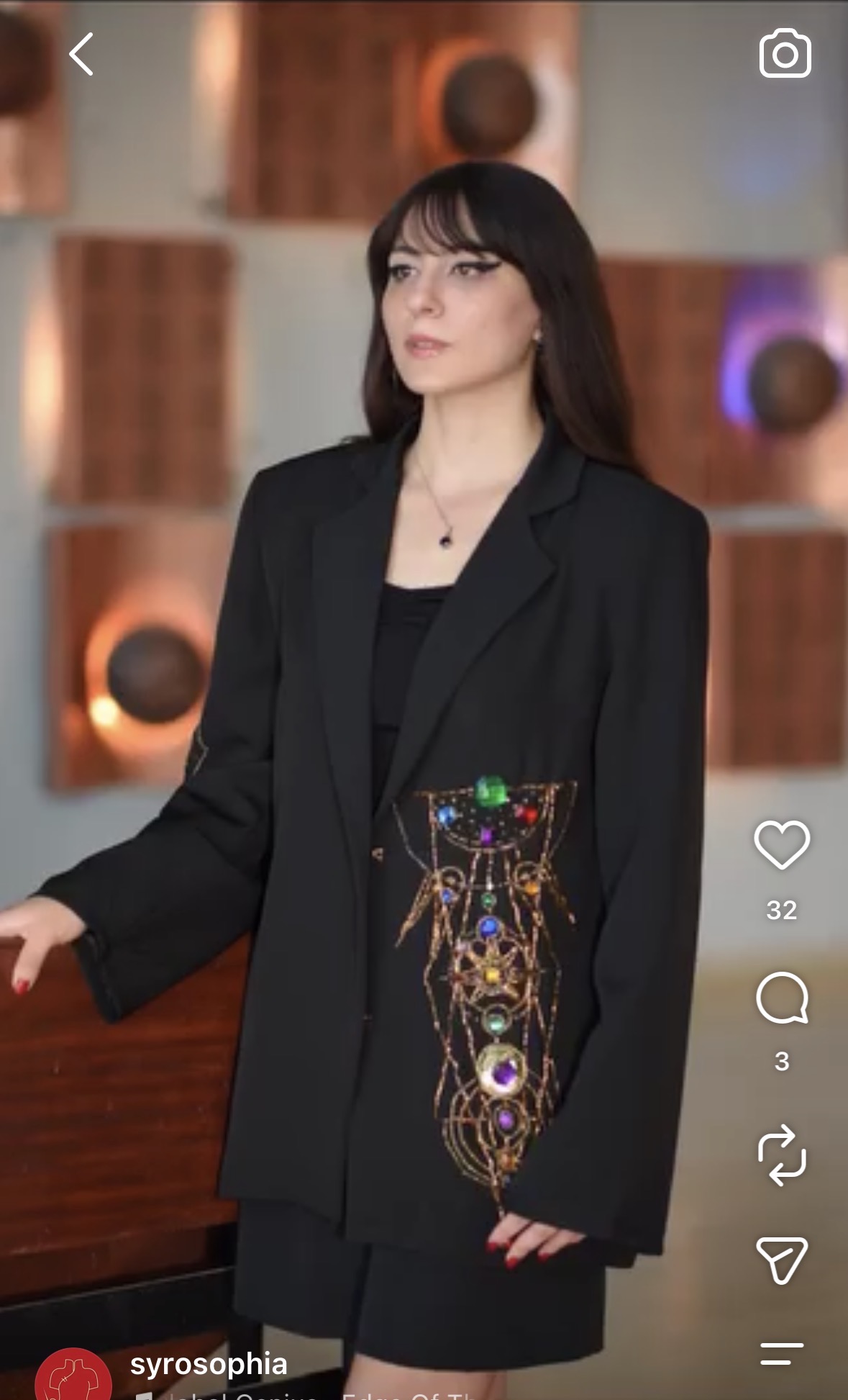Black jacket featuring an ornate jewel-like motif